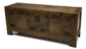 Three quarter perspective view of Chinese softwood low cabinet with bat-shaped fittings and multiple drawers.