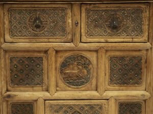 Antique 18th century carved wooden coffer with intricate details.