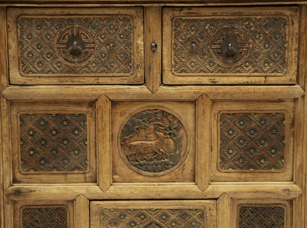 Antique 18th century carved wooden coffer with intricate details.