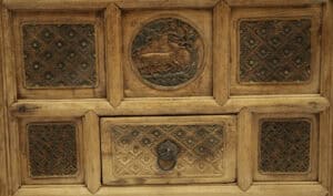 Antique 18th century wooden coffer with intricate carvings symbolising long life and happiness.