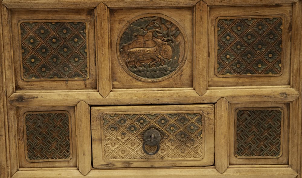 Antique 18th century wooden coffer with intricate carvings symbolising long life and happiness.
