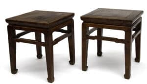 Pair of antique Chinese elmwood square stools with humpback stretchers, ideal for seating and side tables.